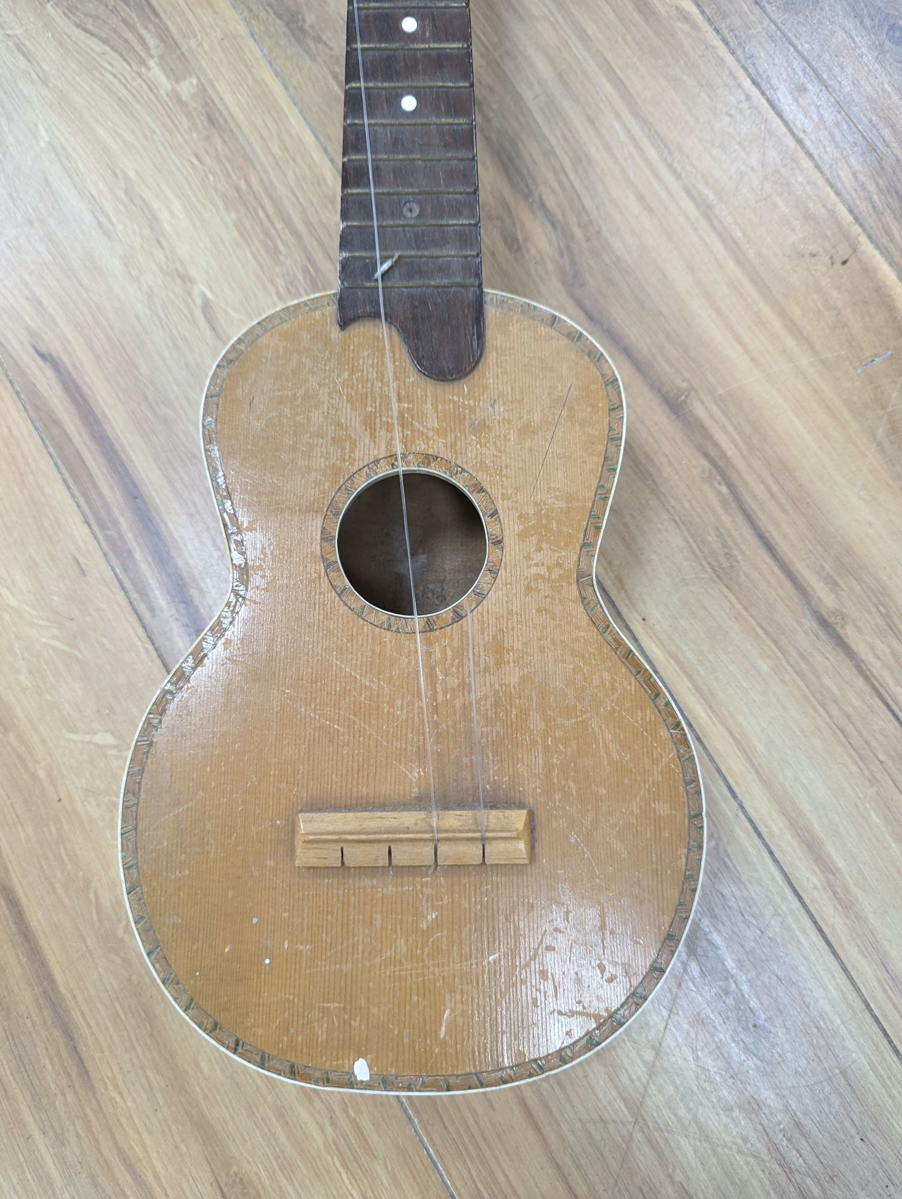 Four 3/4, half and quarter size violins and two ukuleles.